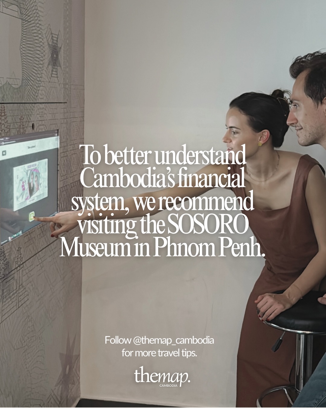 A couple exploring an interactive display at the SOSORO money museum in Phnom Penh