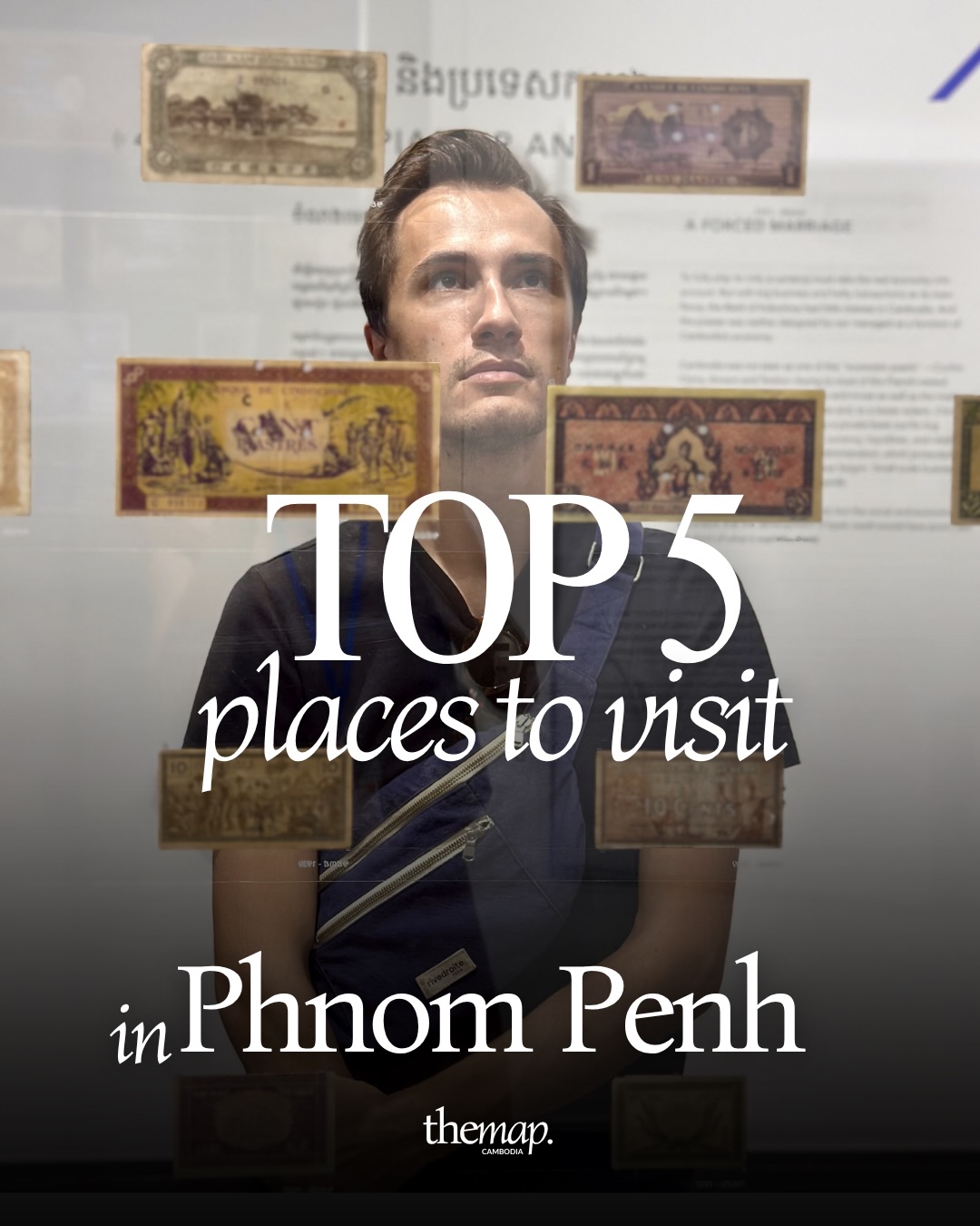 Historic Cambodian banknotes on display behind a visitor at a Phnom Penh museum