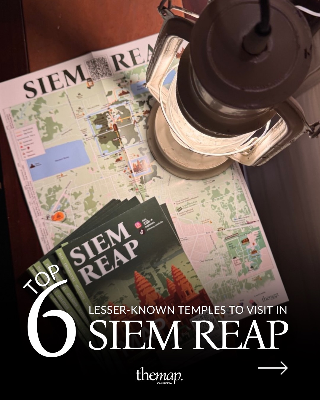 Printed Siem Reap map and pocket guides from The Map Cambodia on a wooden table