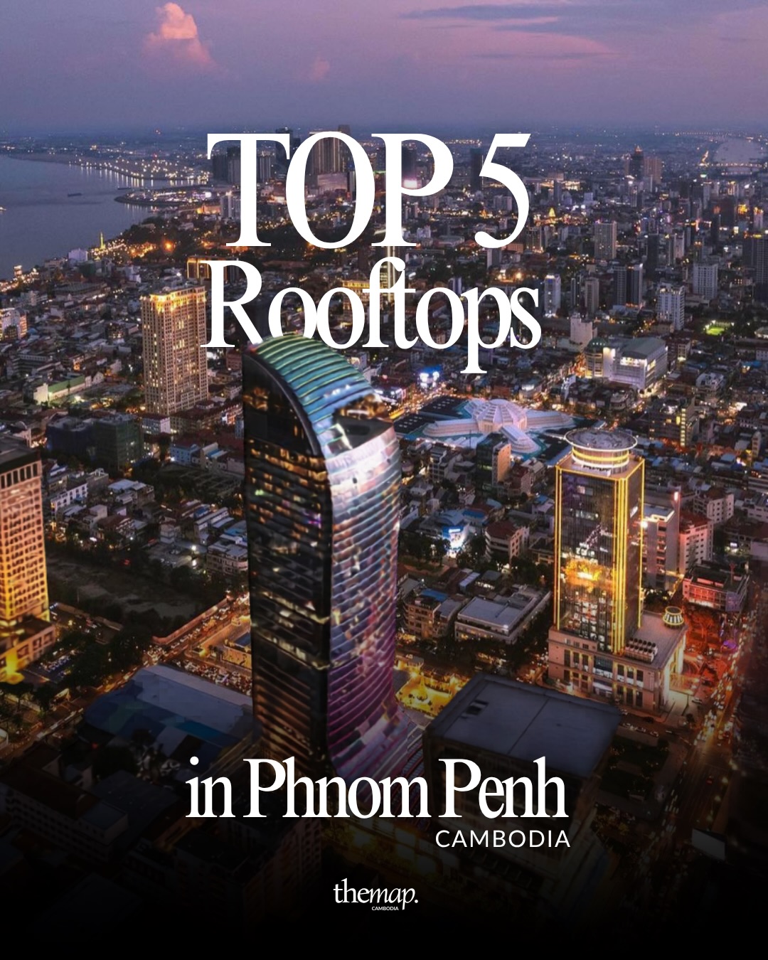 Aerial view of Phnom Penh at dusk with the city skyline and the river lit up
