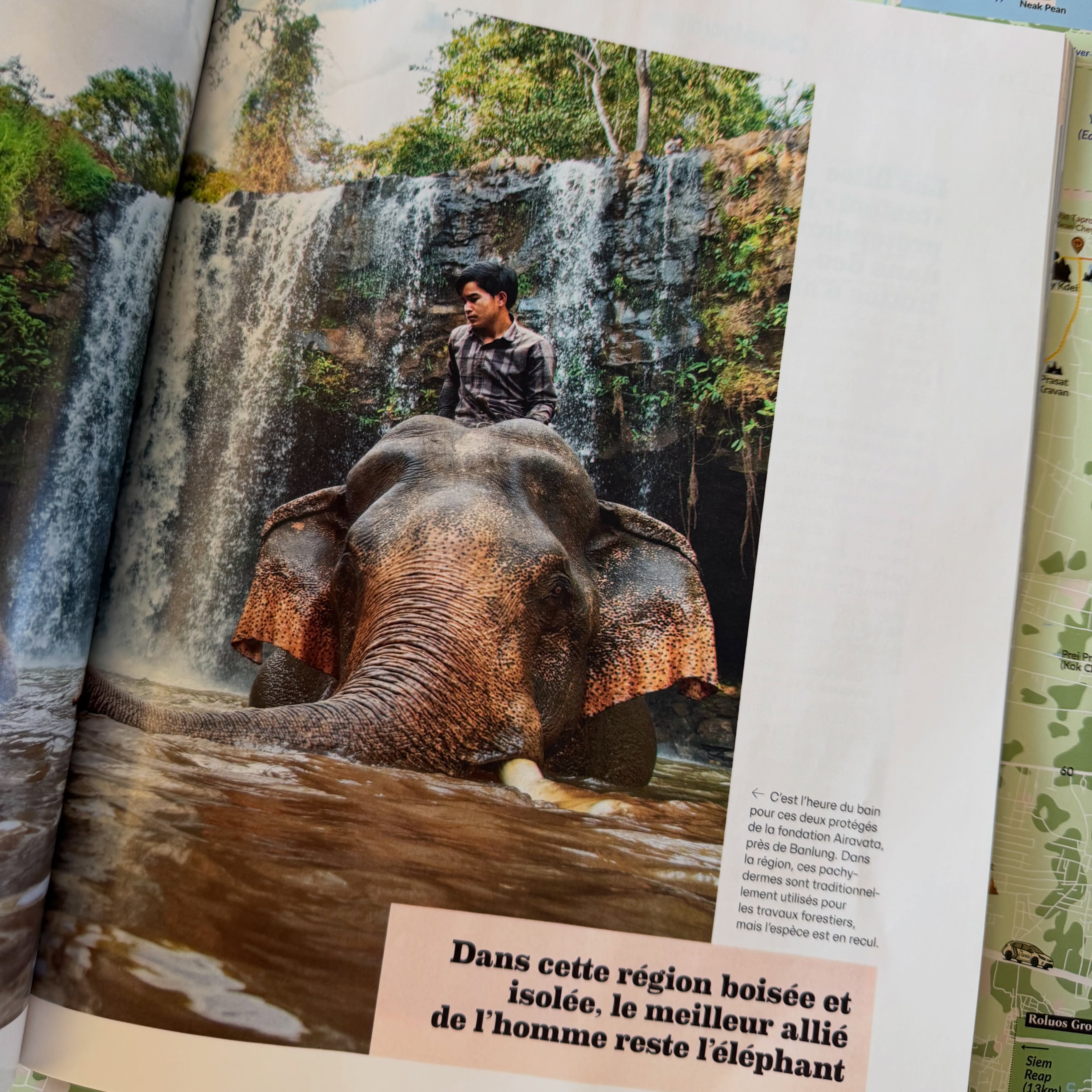 A GEO spread showing a man bathing an elephant at a waterfall near Banlung, Ratanakiri