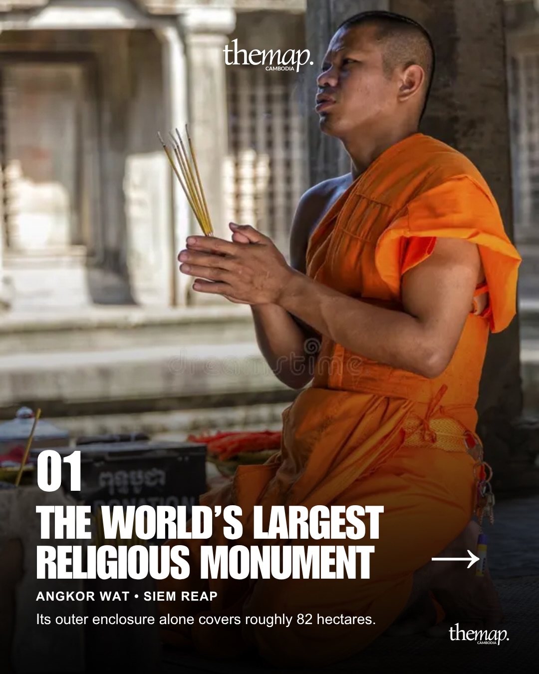 A monk praying inside Angkor Wat, the world's largest religious monument